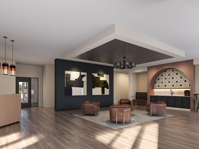 Modern lobby with brown leather chairs, abstract art on the wall, and a bar area with high stools.
